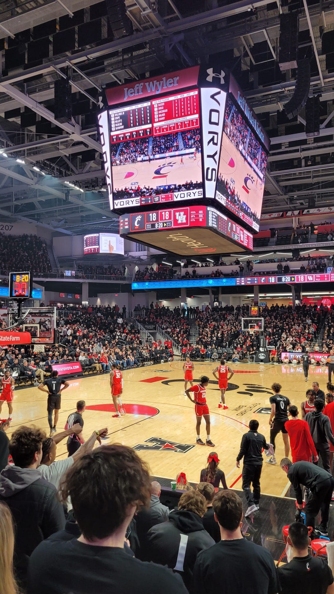View from the stands of a UC Bearcats basketball game at Fifth Third Arena, with the crowd and court in frame