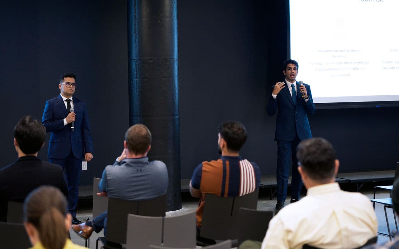 Aniruddhan and his co-founder presenting the PhizzIO pitch to an audience at the Venture Lab demo